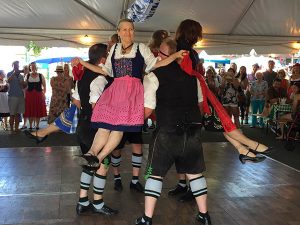Dancing in the authentic German biergarten at the Clayton Oktoberfest