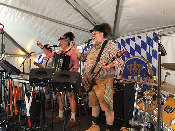 The Internationals band raising a toast in the authentic German beer garden at the Clayton Oktoberfest
